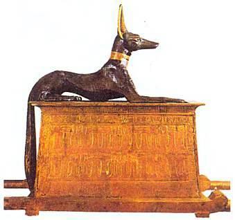 Бог Анубис в облике черного шакала.